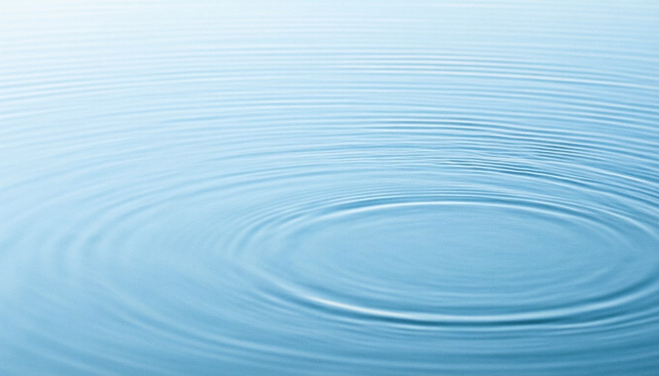Close-up of blue water with gentle circular ripples, creating a serene and relaxing atmosphere suitable for spa and massage backgrounds.