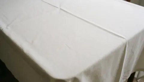 Clean white tablecloth surface with elegant folds, ideal for wedding and event text overlays