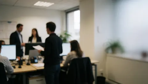 Modern office workspace with empty area for text, people working on computers, professional blurred background