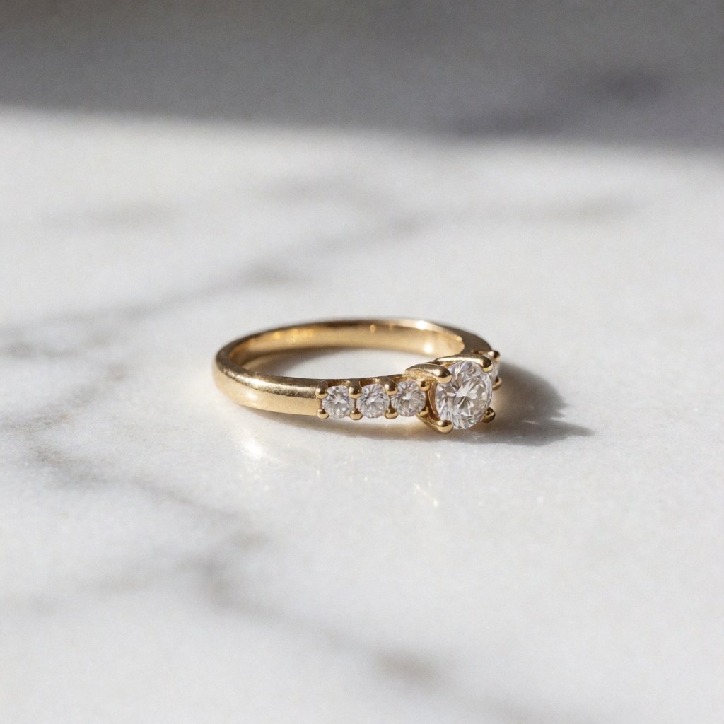 Gold ring with bright diamonds on white marble surface, soft side lighting highlighting the sparkle of the stones
