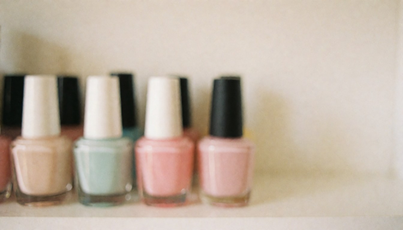 Pastel nail polish bottles arranged on a shelf with a soft background suitable for text overlay