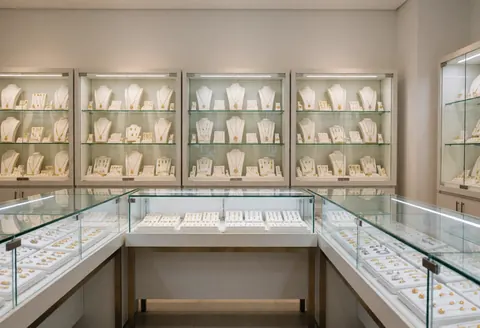 Display cases with necklaces and rings on exhibit in an elegant jewelry store.