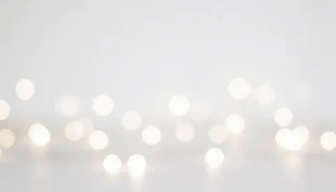 Minimalist white background with soft out-of-focus lights, ideal for placing text or logos in digital designs
