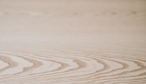 Light wood surface with natural grain patterns and smooth texture, ideal for professional backgrounds.