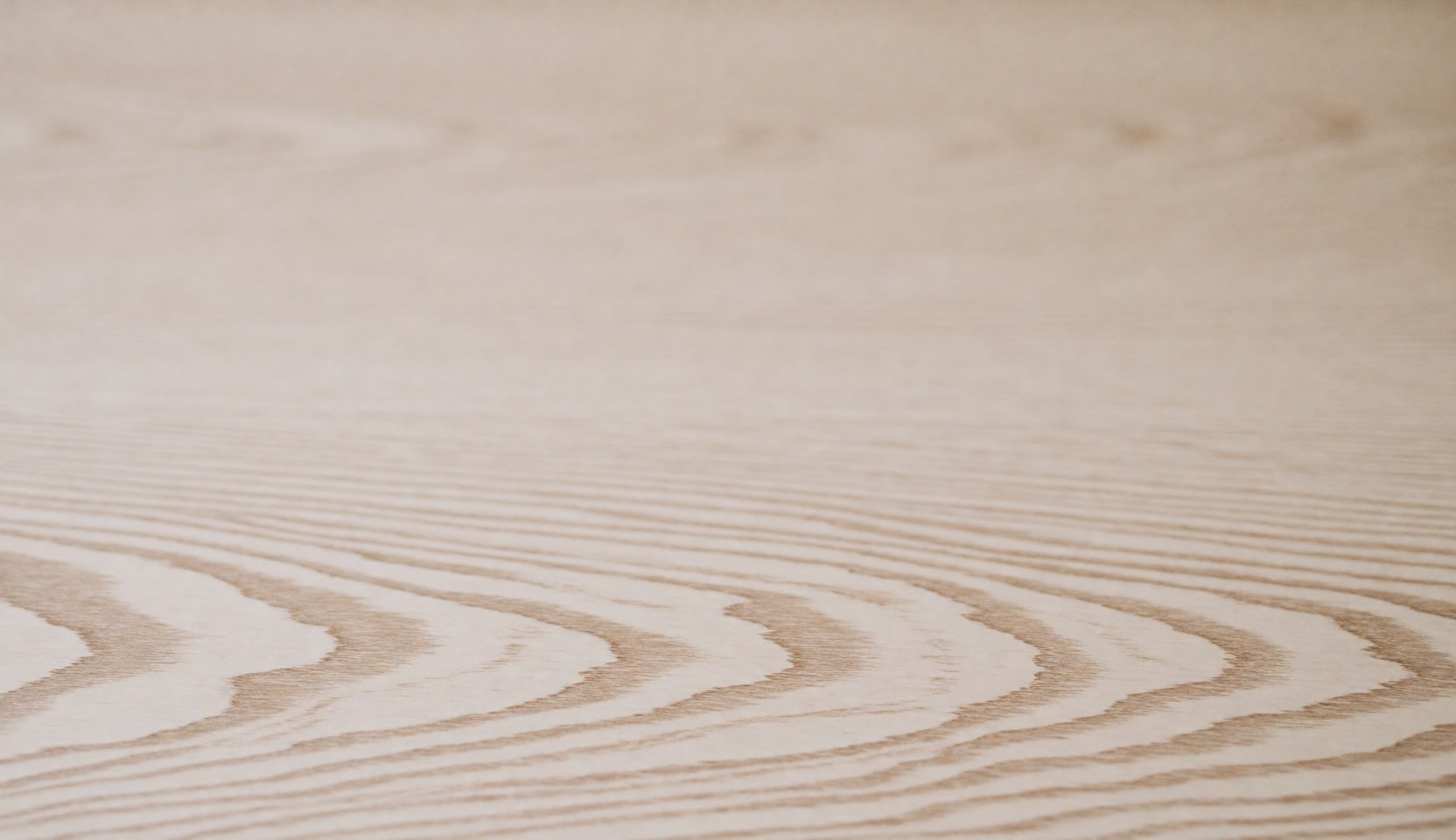 Light wood surface with natural grain patterns and smooth texture, ideal for professional backgrounds.