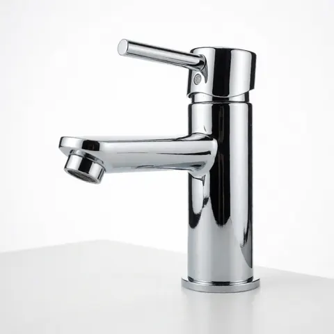 Modern chrome bathroom faucet with single handle on clean white surface for plumbing and decor