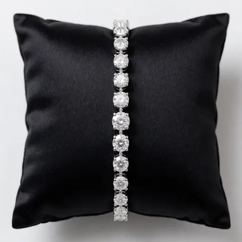 A sparkling diamond bracelet displayed on a black velvet cushion, perfect for jewelry stores or product presentations.