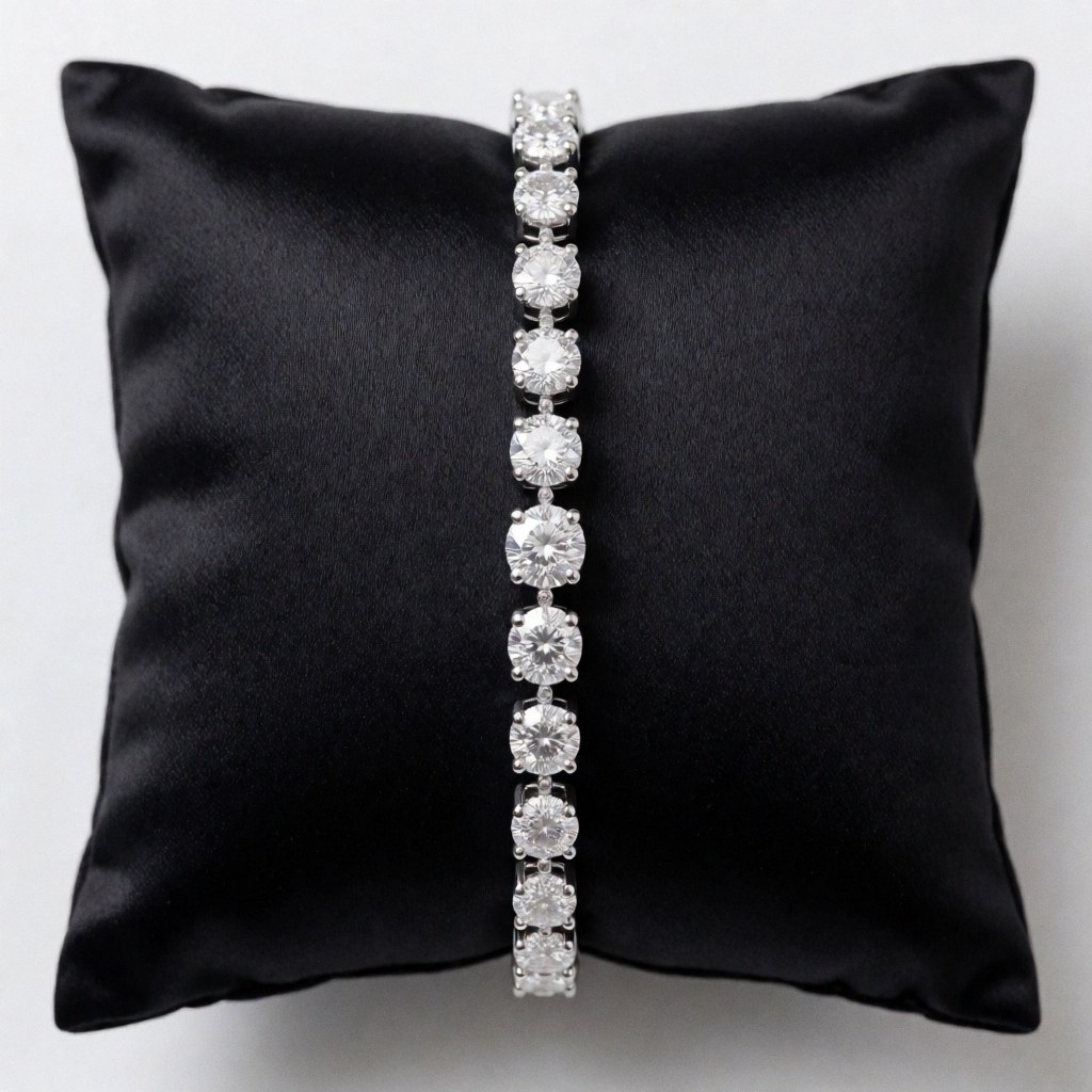 A sparkling diamond bracelet displayed on a black velvet cushion, perfect for jewelry stores or product presentations.