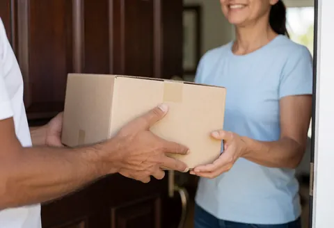 Hands delivering a package to a doorstep, natural lighting, realistic logistics service scene for any business