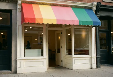 Colorful awning over an open entrance with a clean window, suitable for any business storefront