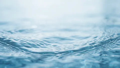 Soft blue water waves with gentle ripples, serving as a clean and professional background for plumbing service websites.