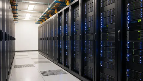 Rows of server racks with blue indicator lights in a clean data center hallway with polished floors and overhead lighting