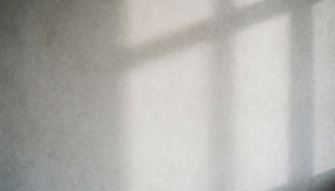 Close-up view of a smooth gray concrete wall surface with soft natural lighting and subtle shadows, ideal for architectural design and interior projects