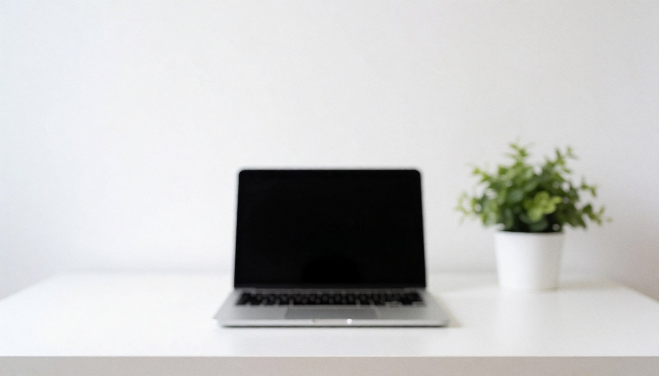 A white laptop sits on a white desk next to a small potted plant, providing a clean background for it support business text.