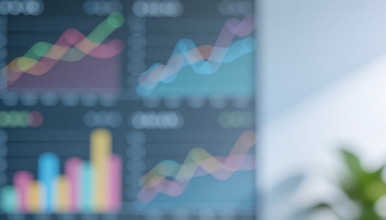 Blurred background of digital data charts with colorful lines and bars on a screen.
