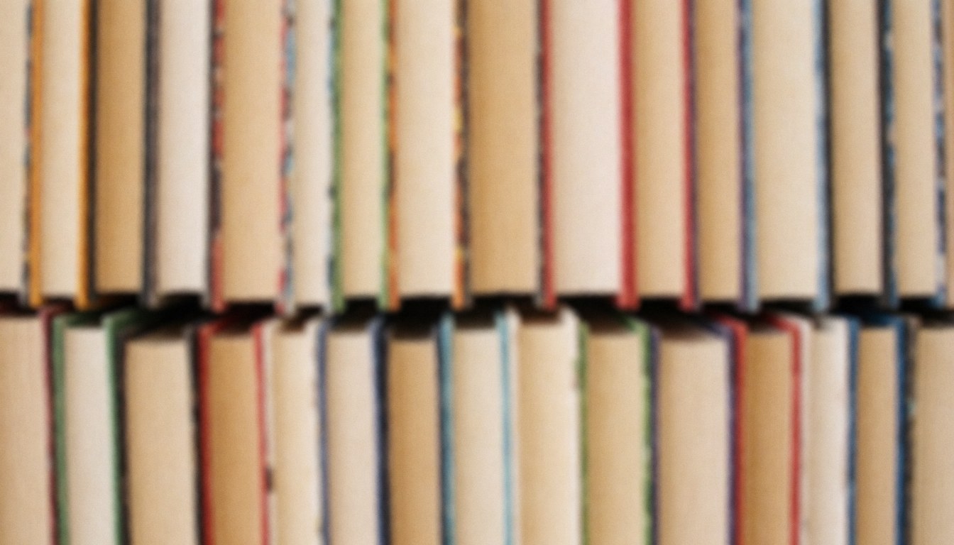 Background of books stacked on a shelf, with colorful spines for web or editorial design.