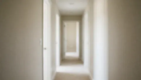 A clean, minimalist beige wall with a white door and hallway, serving as a neutral background for business text and presentations