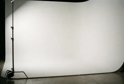 A seamless white cyclorama wall used as a professional background for corporate headshots and business photography in a studio setting