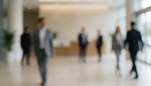 A soft focus image of a modern office corridor with neutral beige and gray tones, ideal for corporate presentations and business text backgrounds