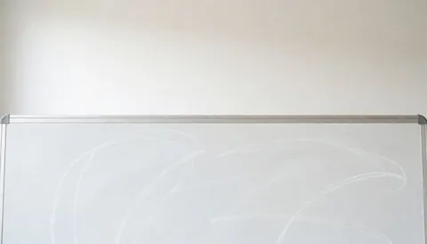 Clean white chalkboard background with faint chalk lines, ideal for educational text overlays in university or classroom settings.