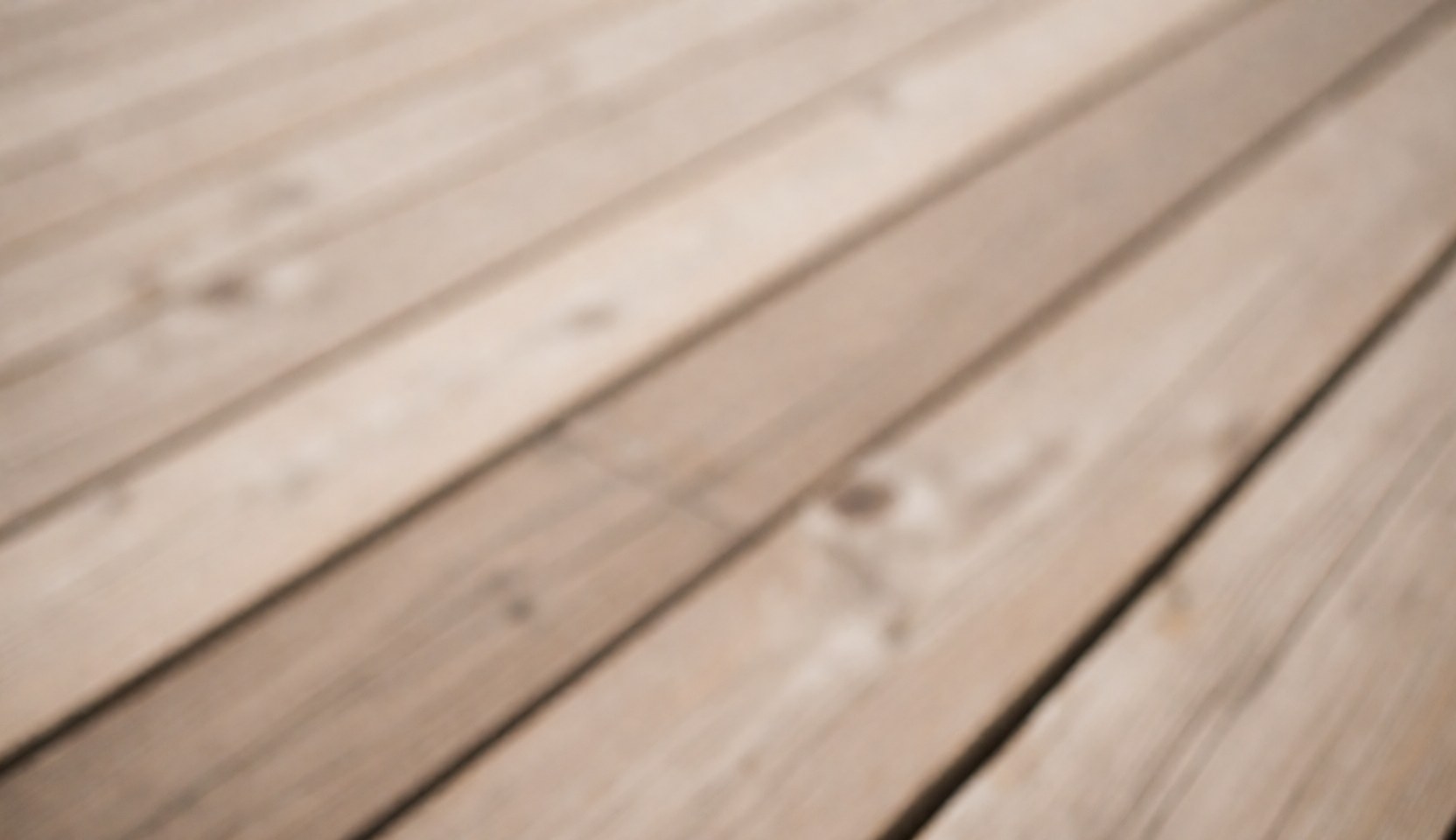 Close-up view of an abstract wooden texture with diagonal lines, serving as a warm and professional background for furniture store websites and interior design projects.