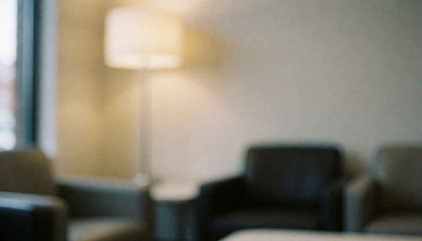 Soft focus background of a contemporary waiting area with chairs and warm lighting, suitable for business presentations and digital marketing overlays.