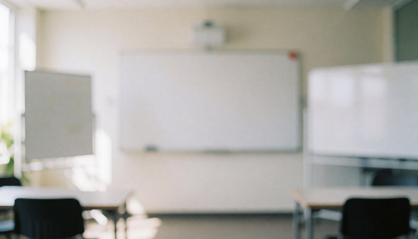 A bright, empty classroom interior featuring rows of desks and chairs, a whiteboard, and natural light, ideal for educational or language school backgrounds.