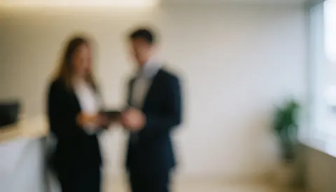 A soft focus background of a modern office reception area with neutral tones, suitable for text overlay and corporate presentations