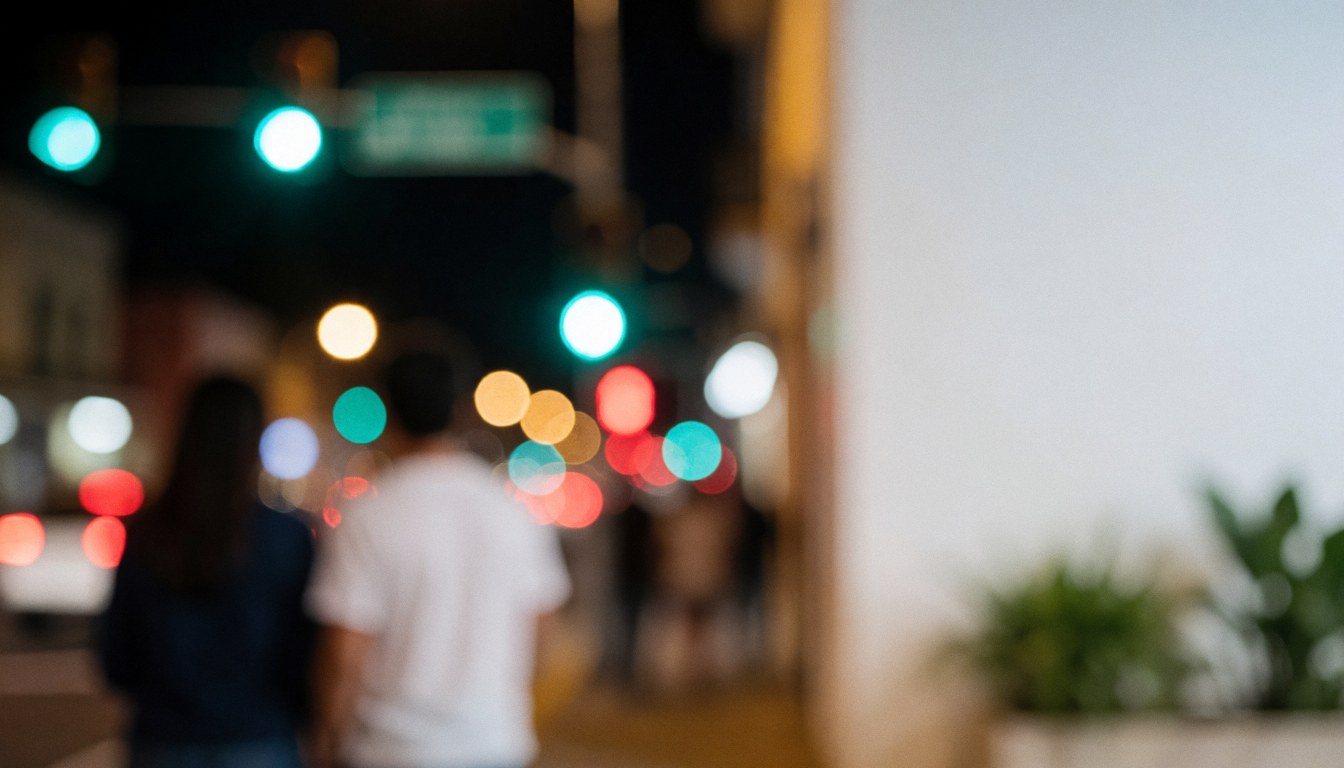 Abstract night city background with blurred traffic lights and streetlamps, white space on the right for text, ideal for urban businesses.
