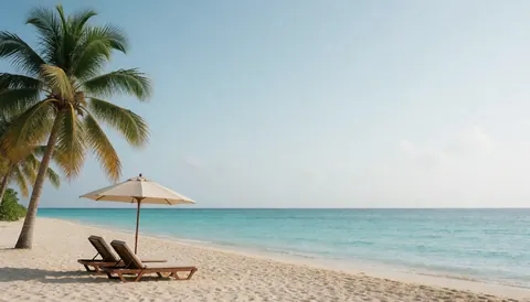 Empty beach chairs and umbrella on white sand under palm trees with turquoise water and clear sky, ideal for travel agency marketing