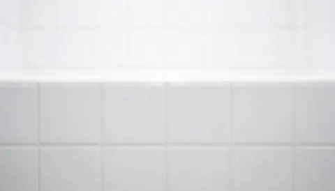 Clean white ceramic tile background suitable for text overlay, ideal for cleaning service marketing and hygiene-related business content