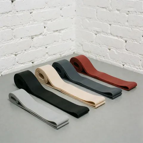 A neat collection of colorful resistance bands arranged in rows, ready for gym workouts and strength training exercises.