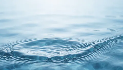 A clean abstract background featuring soft blue water ripples, suitable for plumbing services and professional business designs