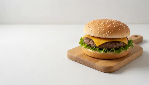A delicious burger with lettuce and cheese on a wooden board, featuring ample white space for text overlay, ideal for fast food advertising and menu design.