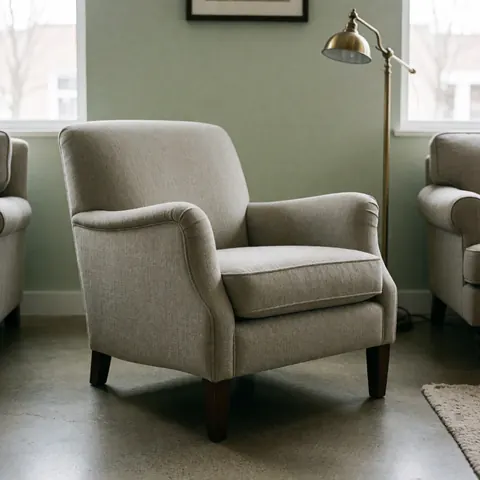 A finished upholstered armchair ready for display in a furniture store, showcasing modern design and comfortable seating for living rooms or reading areas.