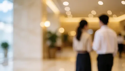 Warm-toned luxury hotel lobby interior with soft bokeh lighting and ample copy space for business text and presentations