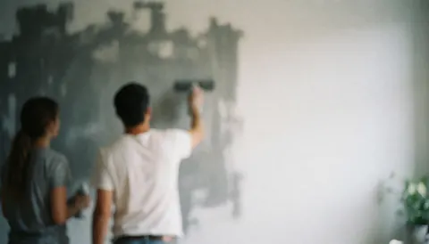 Soft focus background featuring blurred strokes of gray and white paint, ideal for text overlay in house painting business marketing materials.