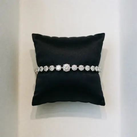 Close-up of a polished diamond resting on a black cushion, ideal for luxury jewelry product presentation and elegant studio photography.