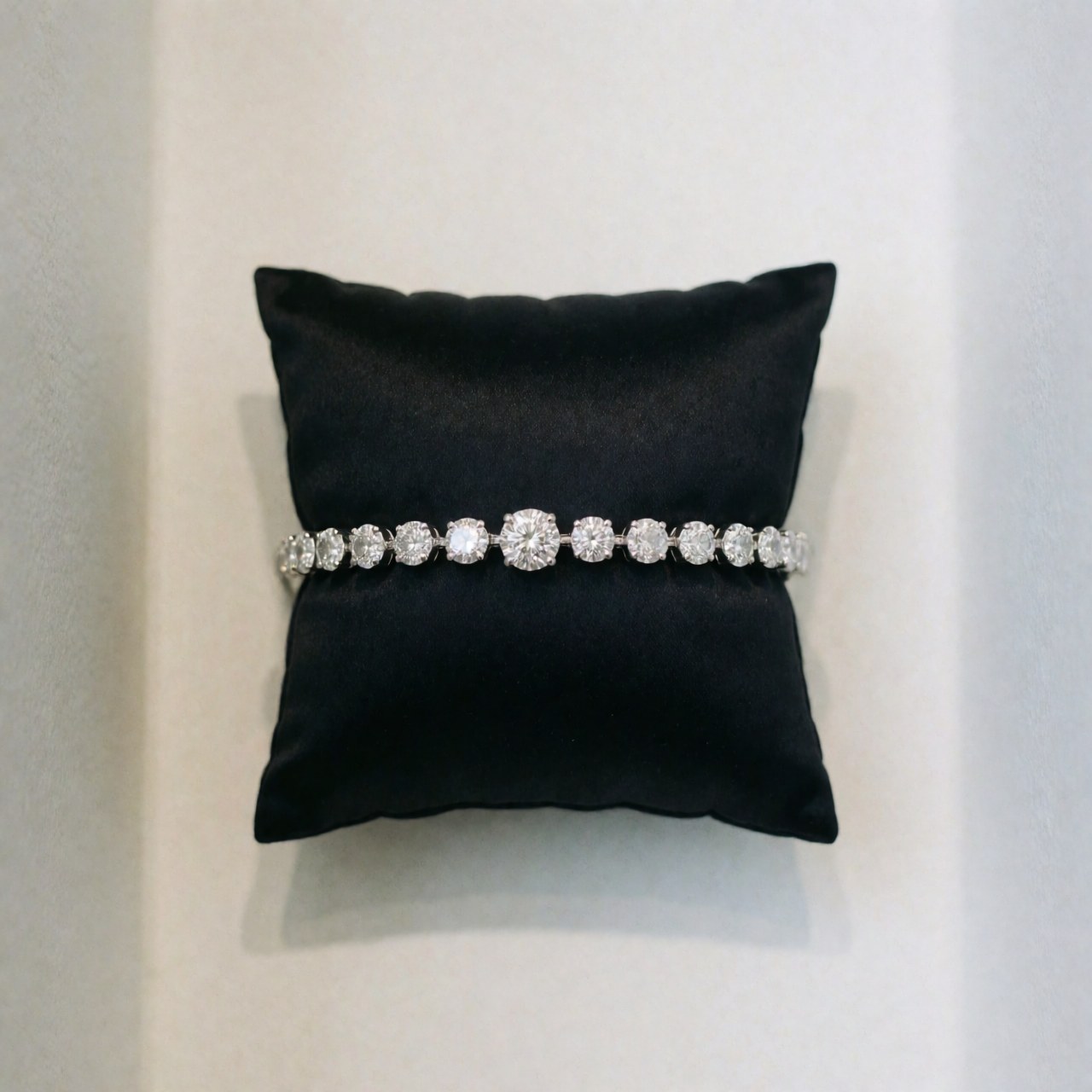 Close-up of a polished diamond resting on a black cushion, ideal for luxury jewelry product presentation and elegant studio photography.