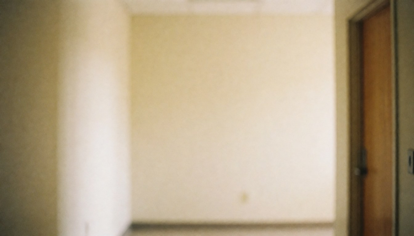 Softly blurred interior hallway of a community center featuring beige walls, wooden door frames, and warm ambient light, providing a clean background for text or presentations.