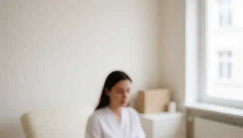 A physiotherapist working in a bright, clean clinic with white walls and natural light, creating a professional and relaxing atmosphere for patient care.