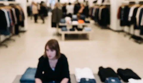 Soft blurred background suitable for text overlay in a clothing store interior setting