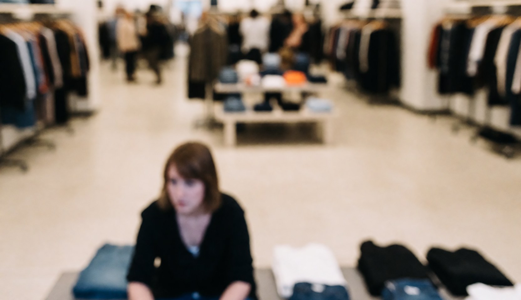 Soft blurred background suitable for text overlay in a clothing store interior setting