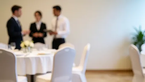 Soft focus background of a bright banquet hall with tables and chairs, ideal for catering business text overlays