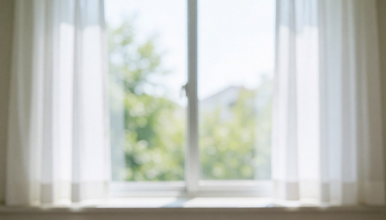A bright window with white curtains letting in natural light, creating a calm and professional background for dental clinic text.