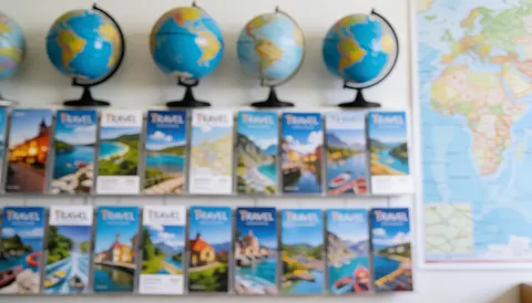 Soft focus background featuring globes, maps, and travel brochures, ideal for travel agency text overlays