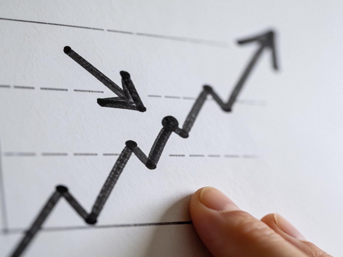 Hand holding a white paper with a hand drawn upward trending graph and arrow, ideal for marketing and business strategy presentations