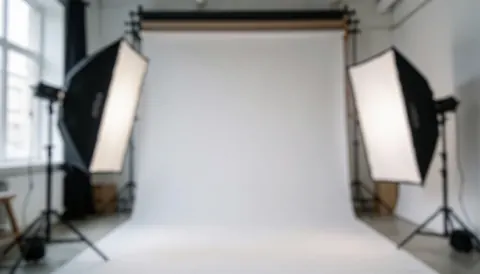 Blurred studio background with lighting equipment and diffusers, providing a clean neutral space for online store text overlays and digital service presentations.