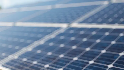A soft, blurred background suitable for solar energy text overlays, featuring clean blue and green tones for professional web design and marketing materials.