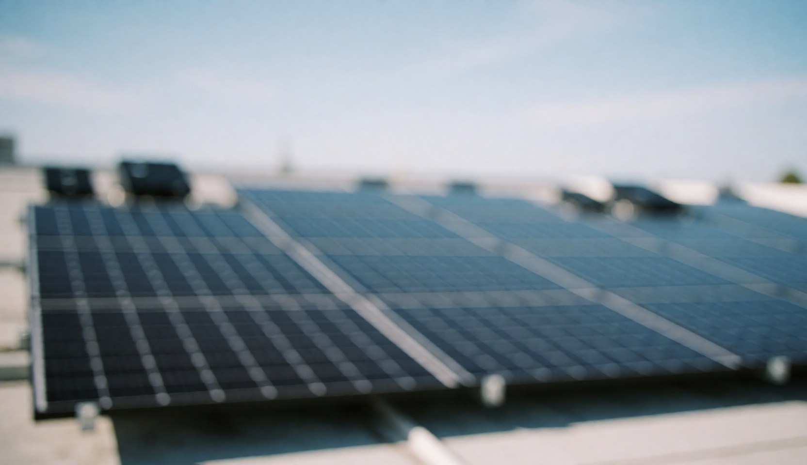 Abstract background of solar panels on a roof with a blue sky, ideal for text and web design